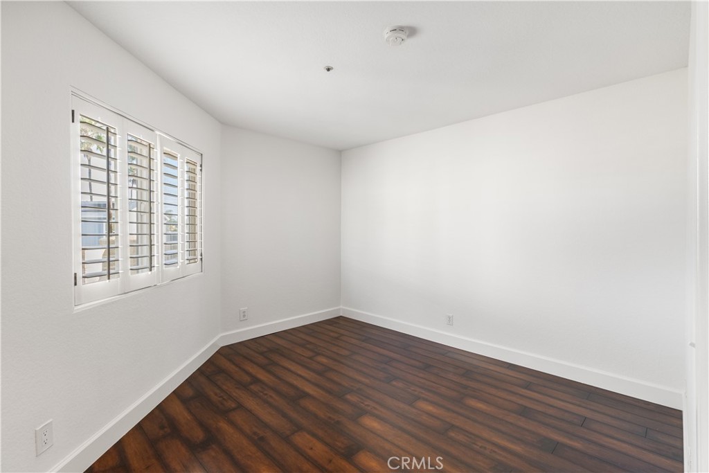 430 Lake Street, Unit 304 Huntington Beach, CA 92648 - Photo 36 of 46 an empty room with wooden floor and windows
