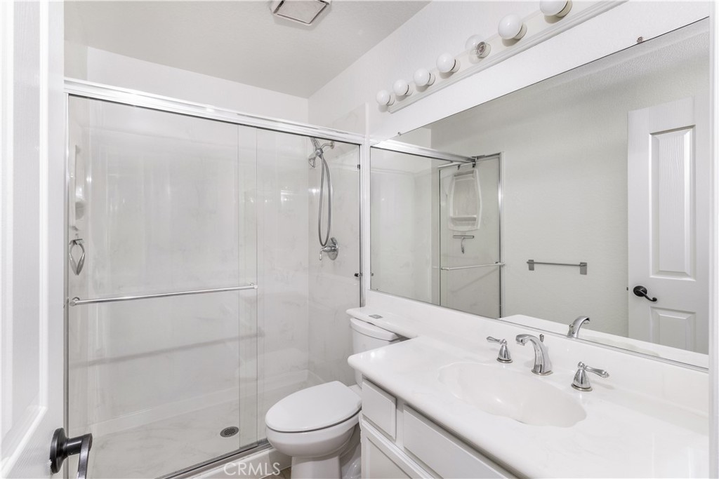430 Lake Street, Unit 304 Huntington Beach, CA 92648 - Photo 39 of 46 a bathroom with a sink shower and a toilet