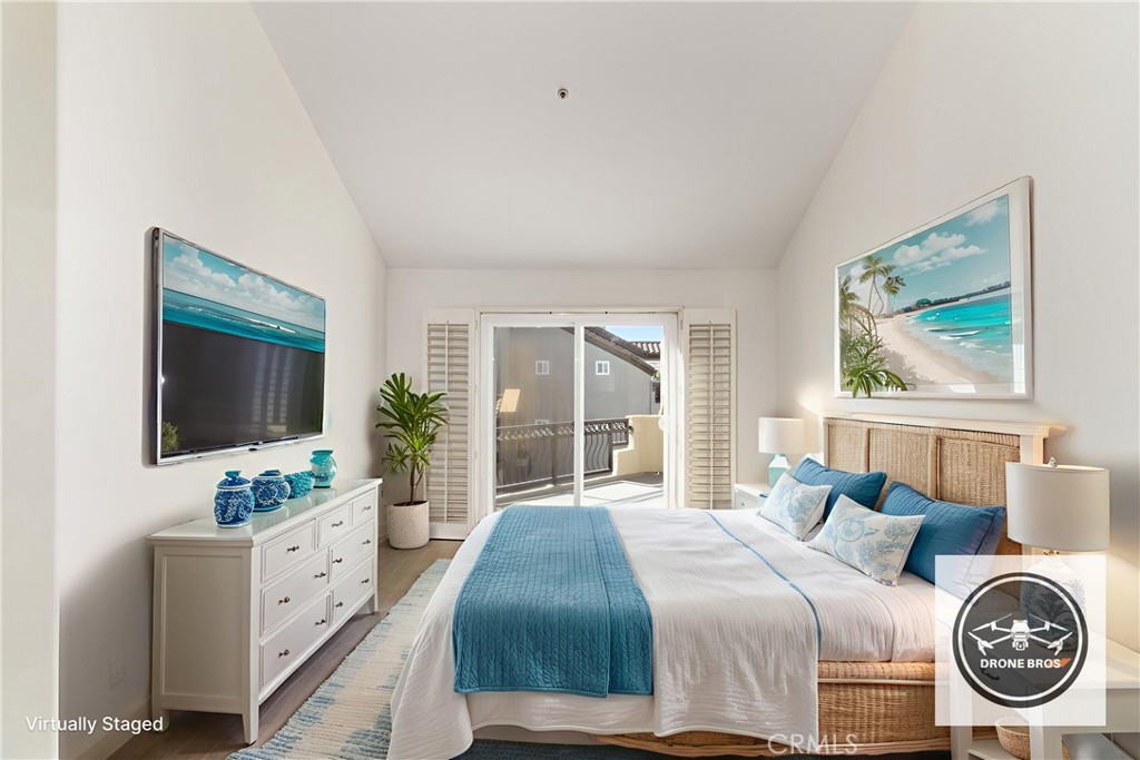 430 Lake Street, Unit 304 Huntington Beach, CA 92648 - Photo 4 of 46 a spacious bedroom with a bed and a flat screen tv
