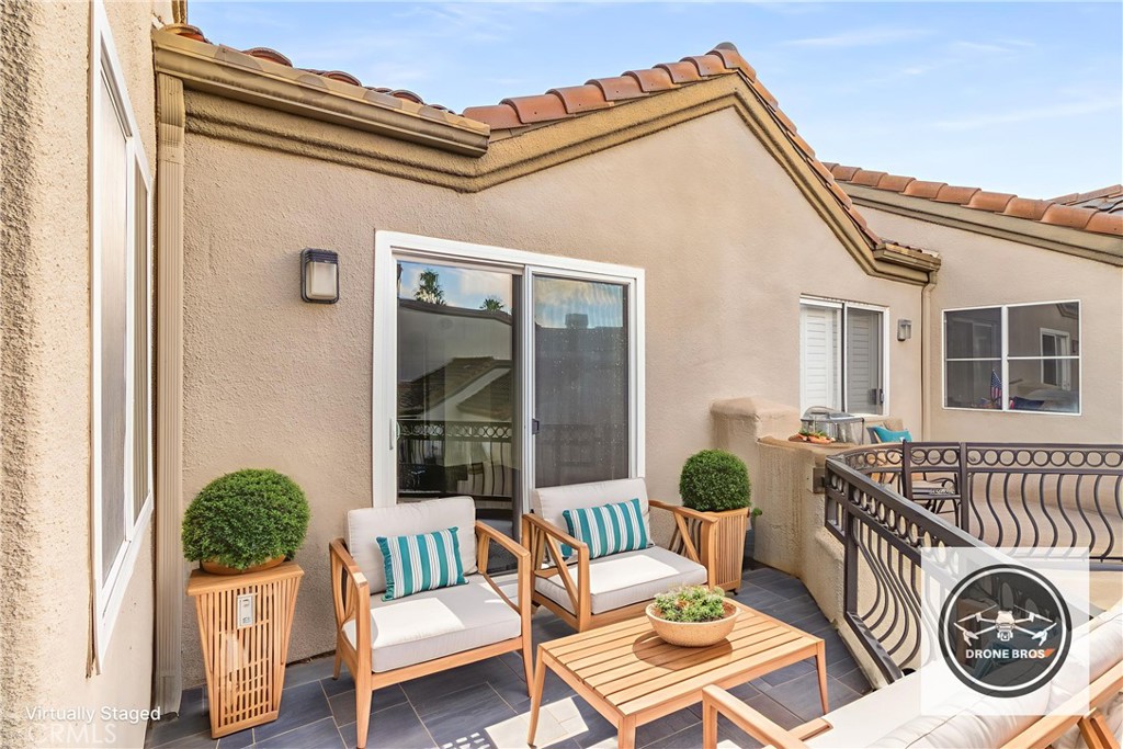 430 Lake Street, Unit 304 Huntington Beach, CA 92648 - Photo 5 of 46 a balcony with furniture and a potted plant