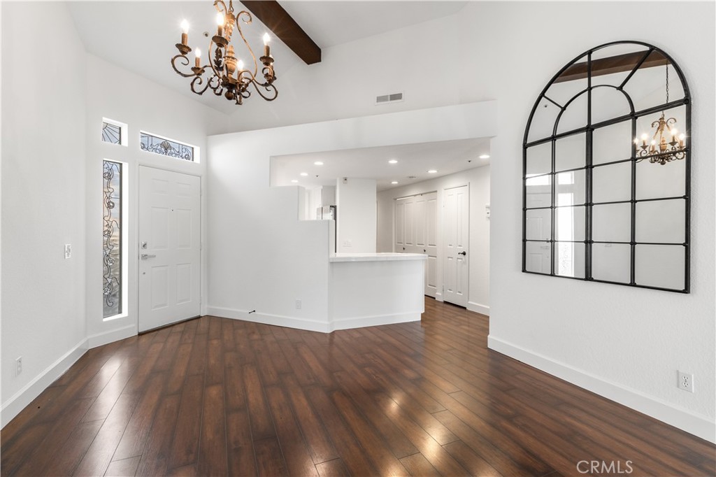 430 Lake Street, Unit 304 Huntington Beach, CA 92648 - Photo 7 of 46 a view of an empty room with wooden floor and a window