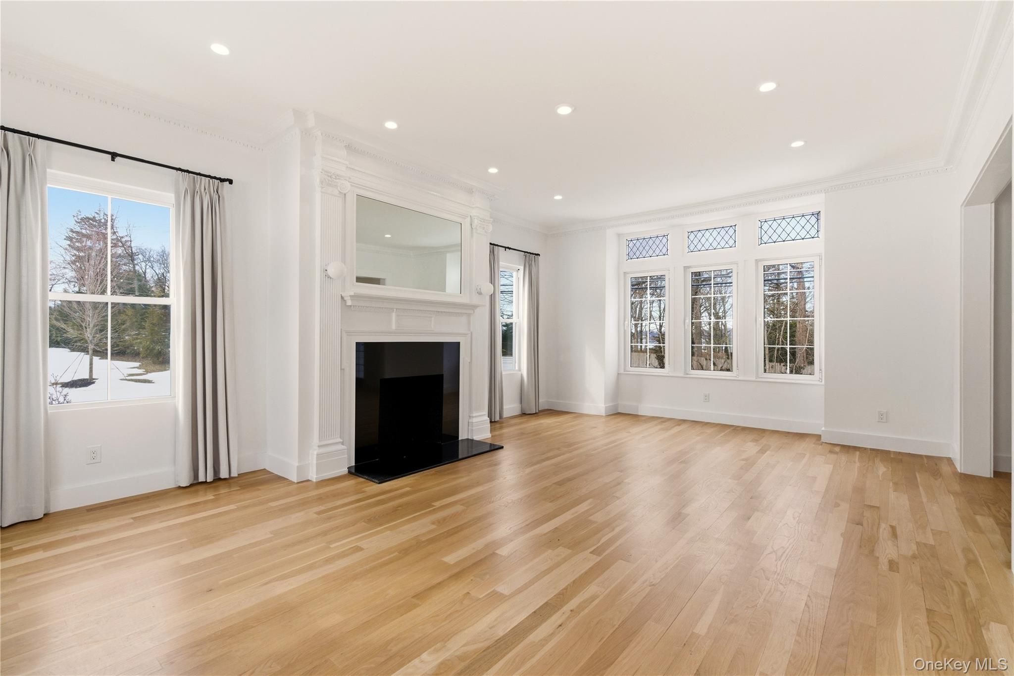 77 Cove Road Oyster Bay, NY 11771 - Photo 17 of 45 a view of an empty room with a window and fireplace