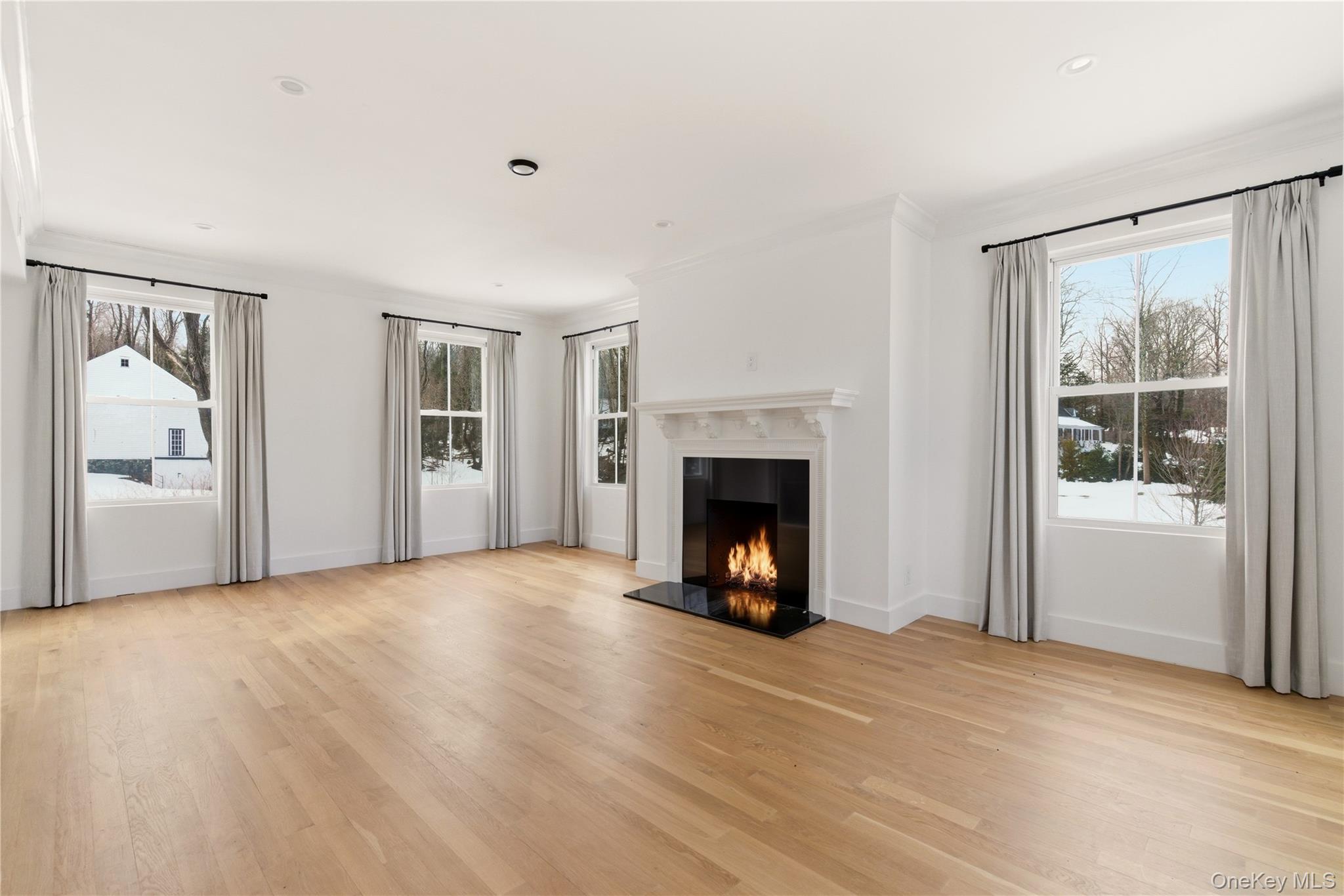 77 Cove Road Oyster Bay, NY 11771 - Photo 18 of 45 a view of an empty room with window and a fireplace