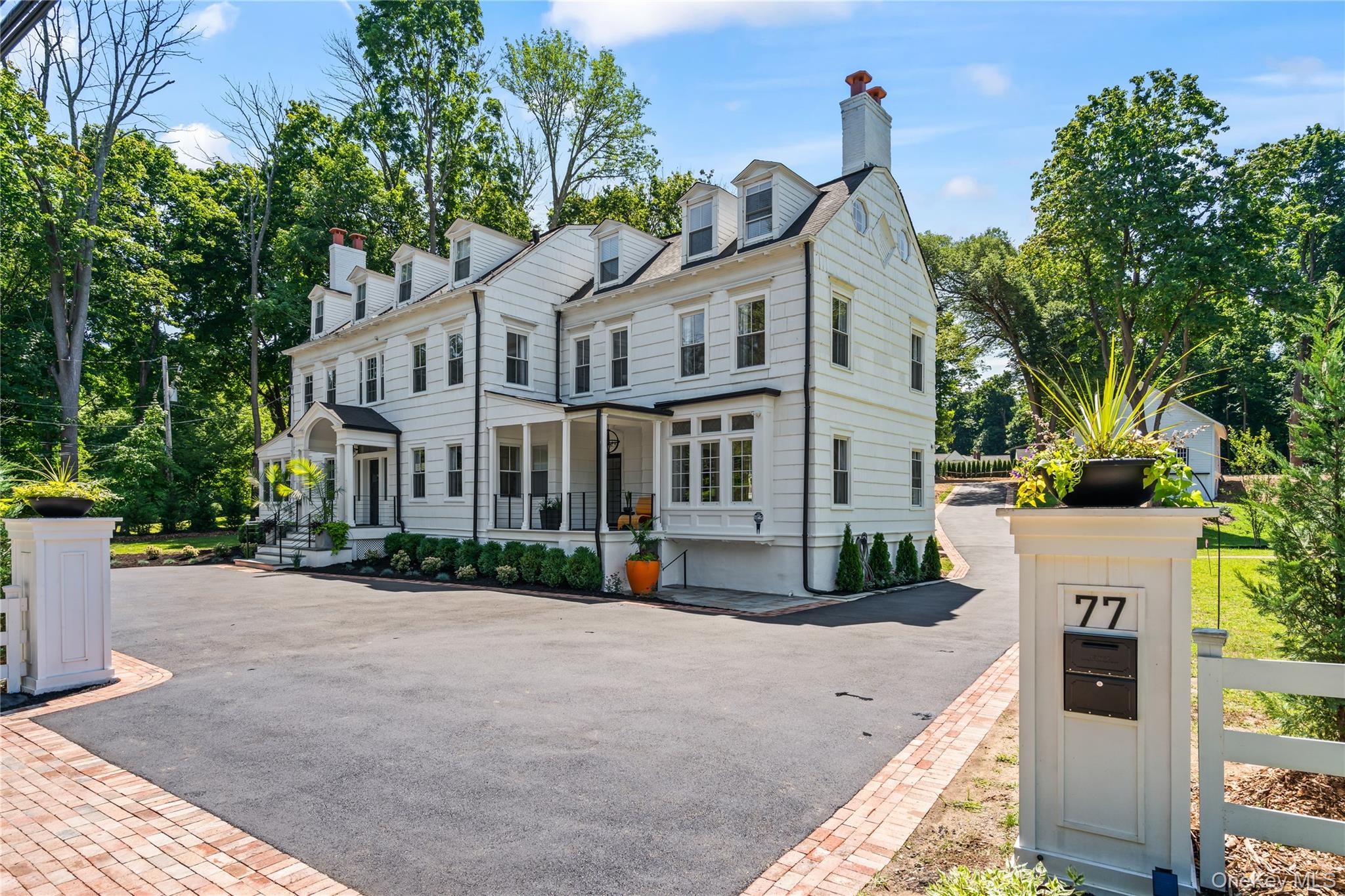 77 Cove Road Oyster Bay, NY 11771 - Photo 2 of 45 a view of a white house with a yard and potted plants