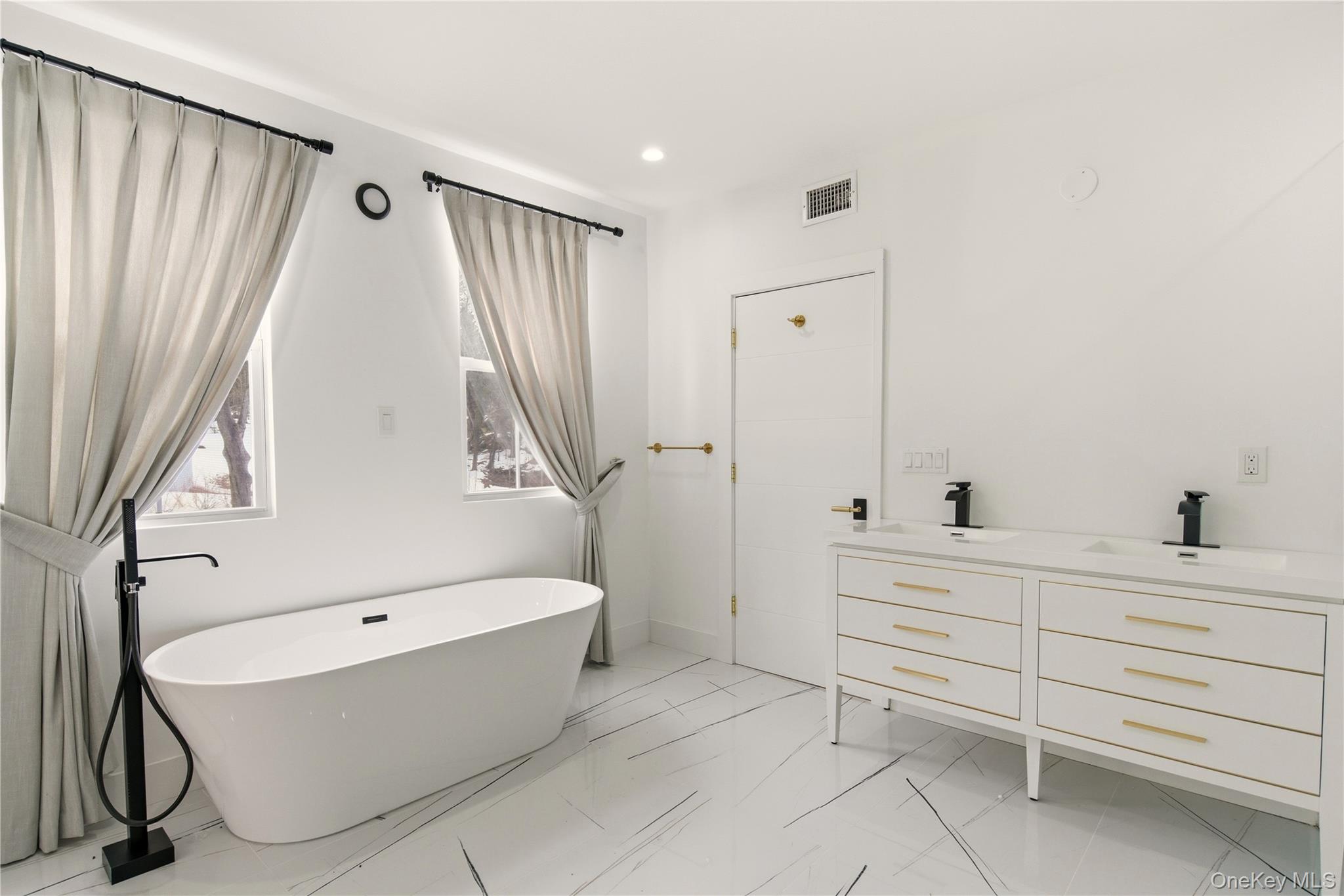 77 Cove Road Oyster Bay, NY 11771 - Photo 21 of 45 a bathroom with a bathtub and a sink