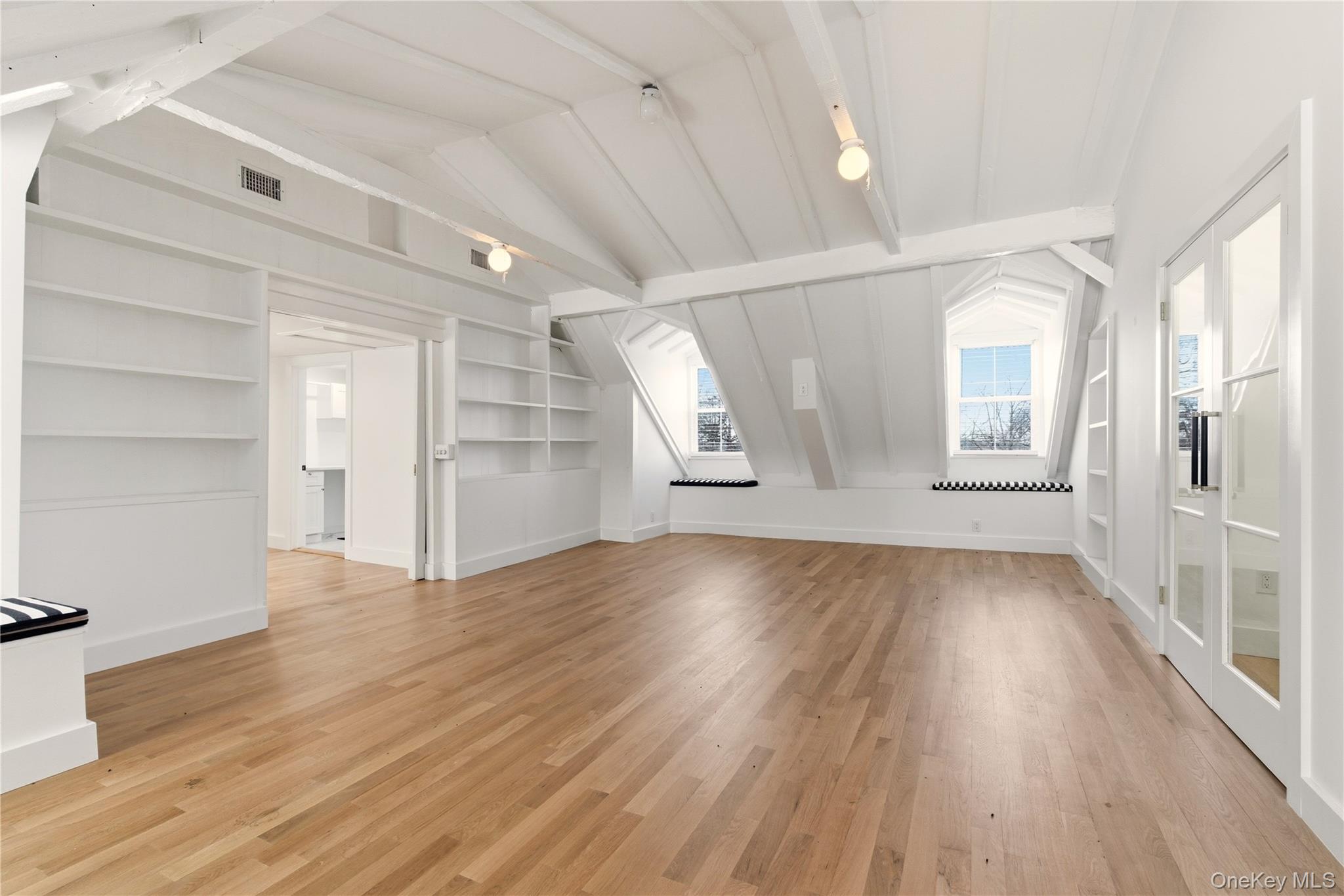 77 Cove Road Oyster Bay, NY 11771 - Photo 24 of 45 wooden floor in an empty room with a window