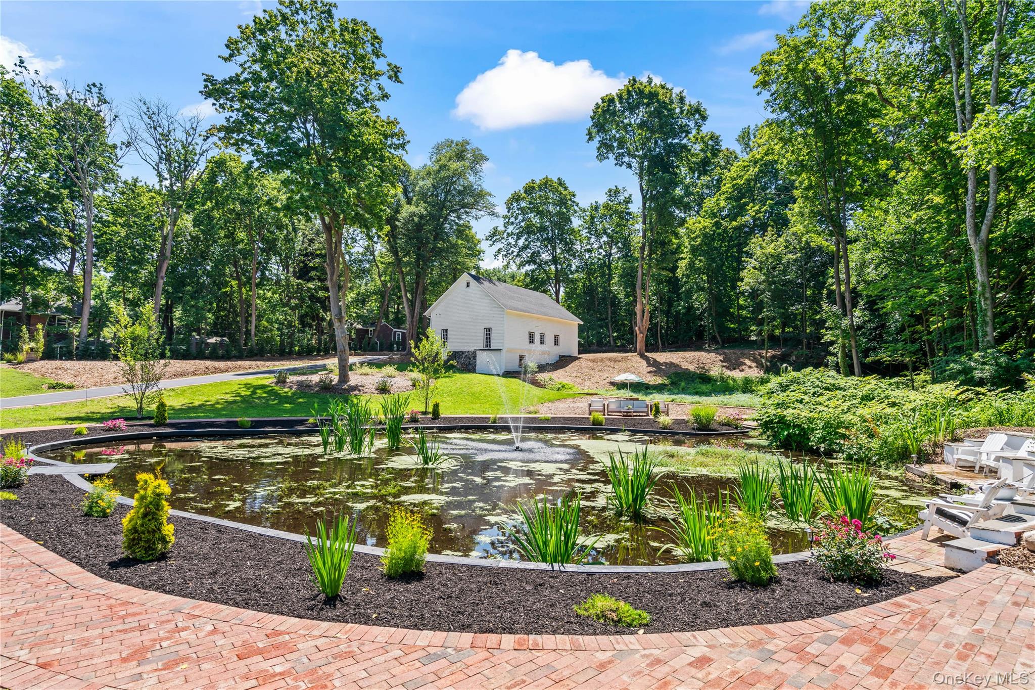 77 Cove Road Oyster Bay, NY 11771 - Photo 32 of 45 a view of a swimming pool with a patio and plants