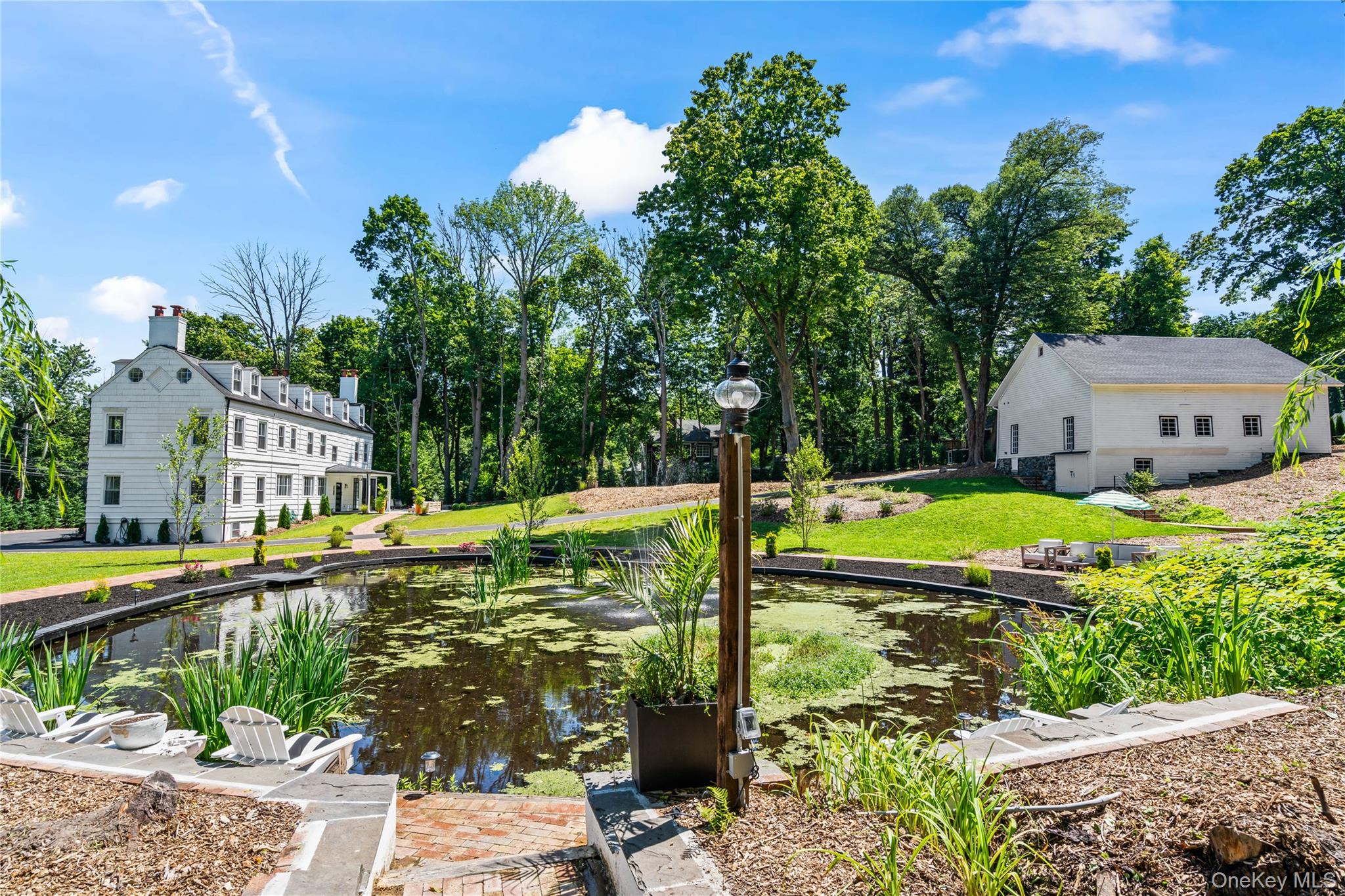 77 Cove Road Oyster Bay, NY 11771 - Photo 33 of 45 a view of a swimming pool with a garden