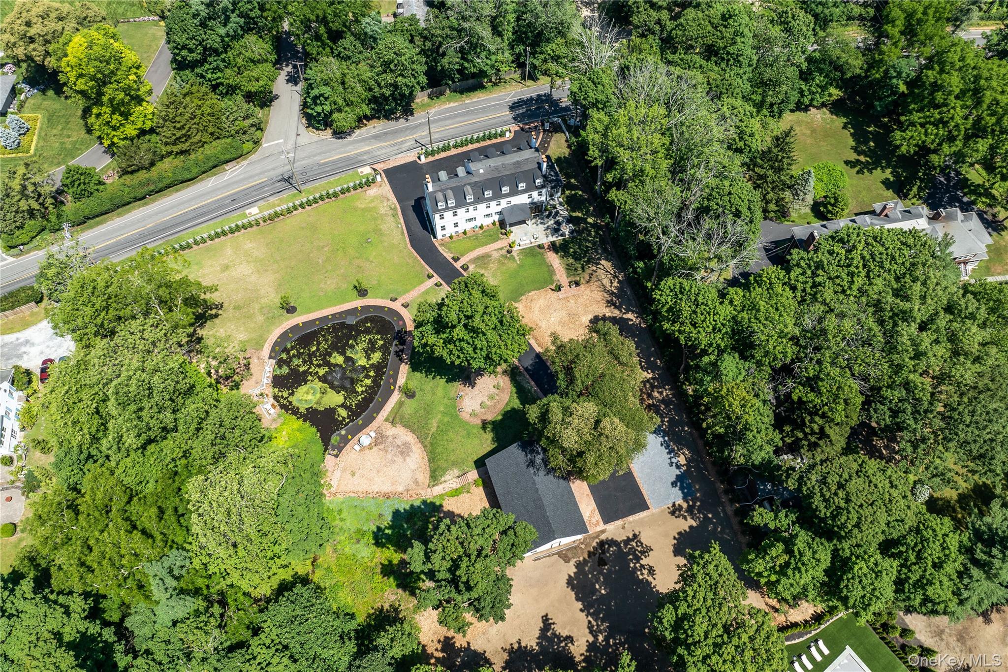 77 Cove Road Oyster Bay, NY 11771 - Photo 36 of 45 an aerial view of a house with a swimming pool