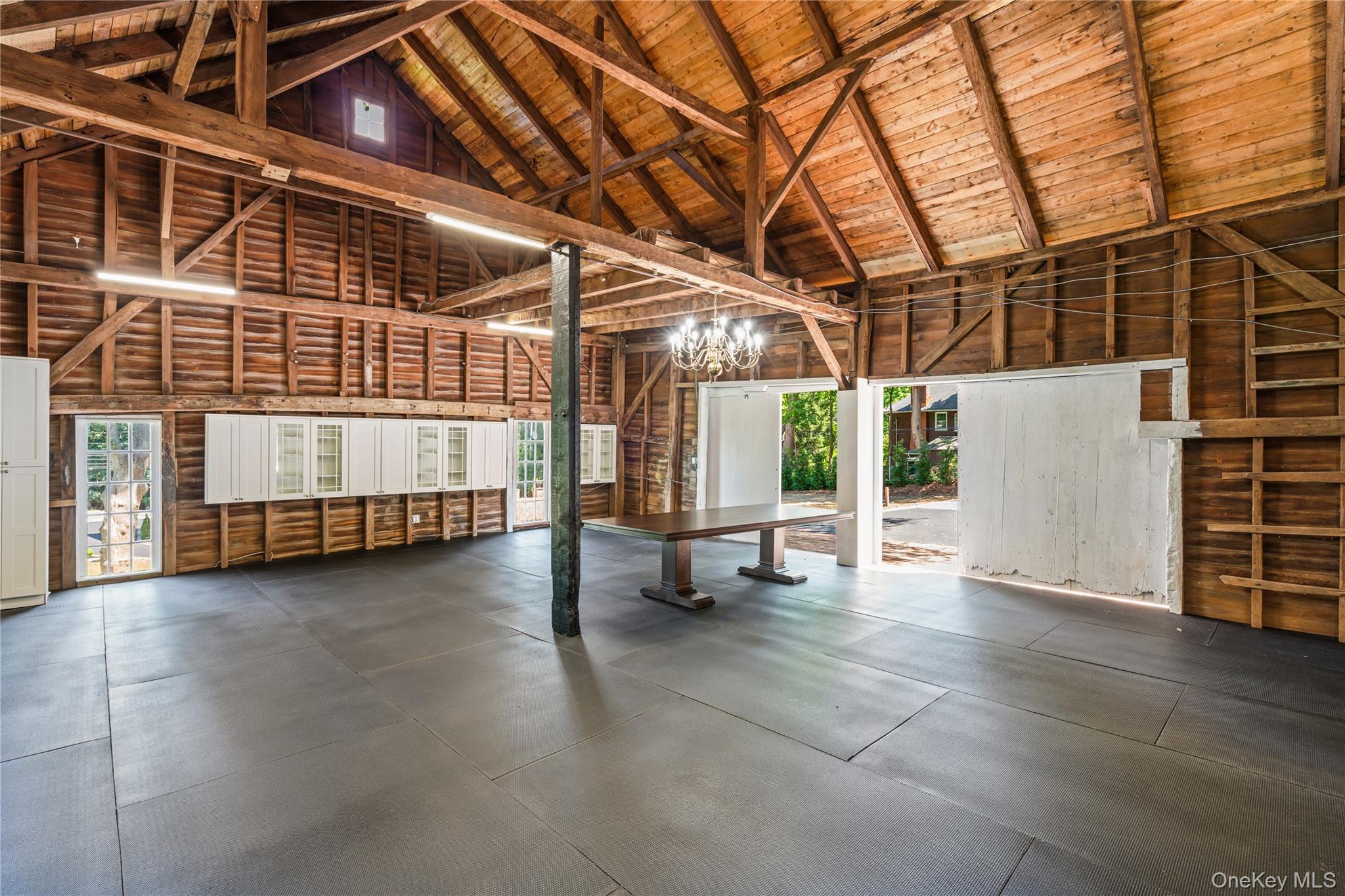 77 Cove Road Oyster Bay, NY 11771 - Photo 39 of 45 a view of an empty room with wooden floor and windows