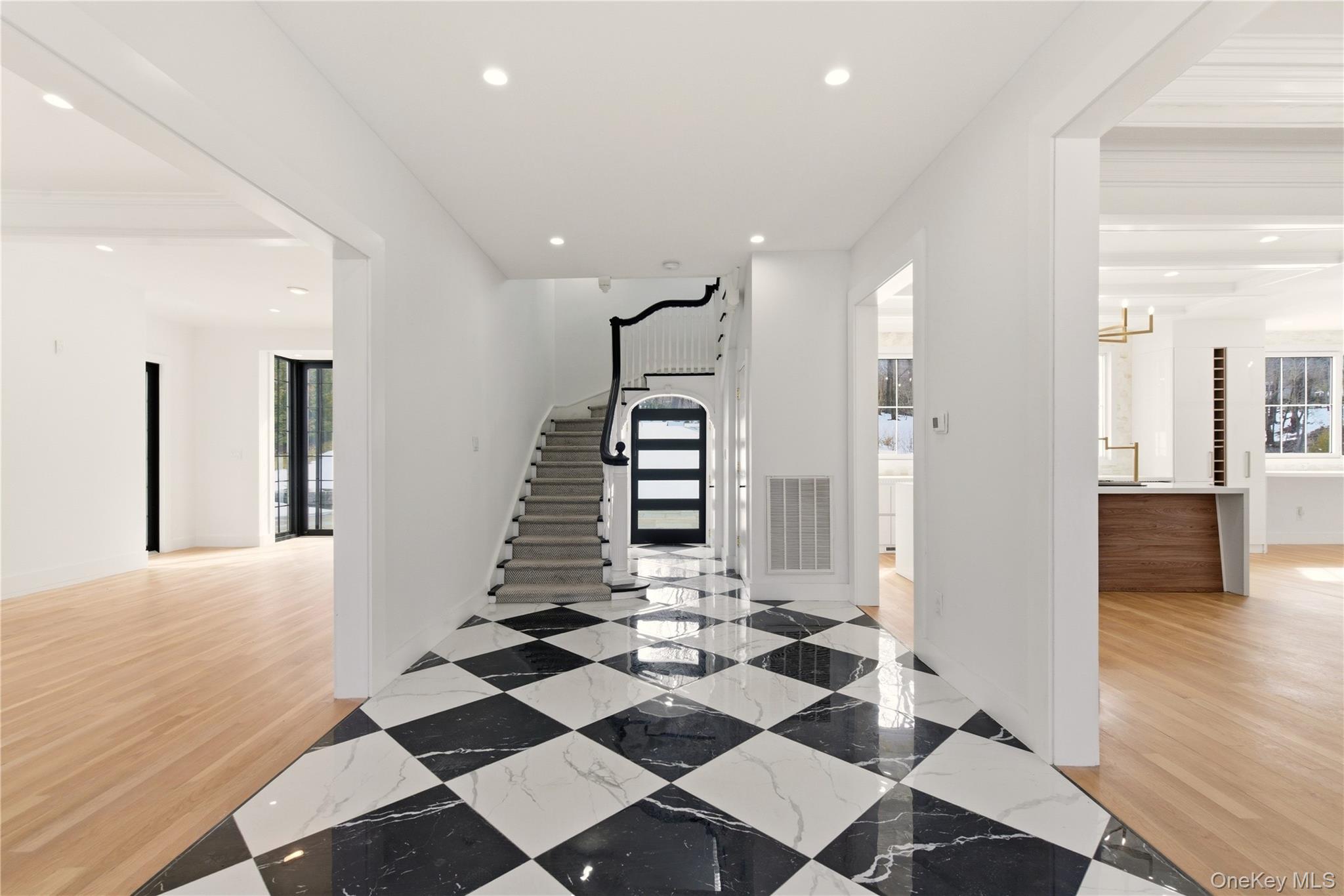 77 Cove Road Oyster Bay, NY 11771 - Photo 6 of 45 a view of a hallway with wooden floor windows and a living room
