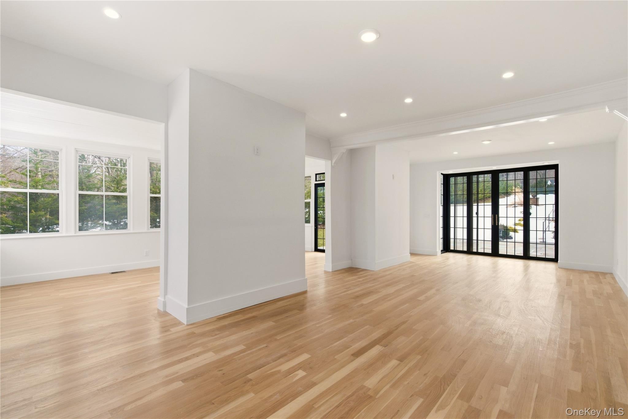 77 Cove Road Oyster Bay, NY 11771 - Photo 8 of 45 a view of an empty room with wooden floor and a window
