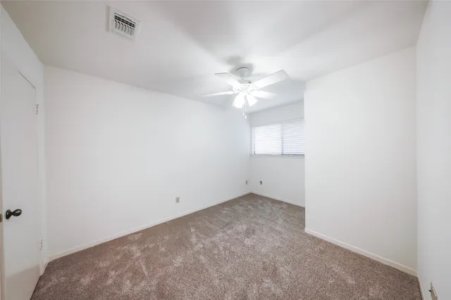 a view of a livingroom with wooden floor and staircase