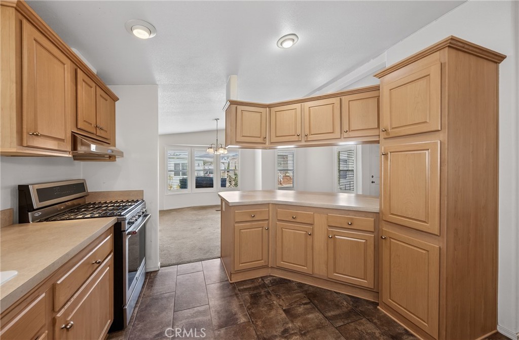 12367 4th Street, Unit 71 Yucaipa, CA 92399 - Photo 13 of 25 a kitchen with granite countertop cabinets stainless steel appliances and a sink