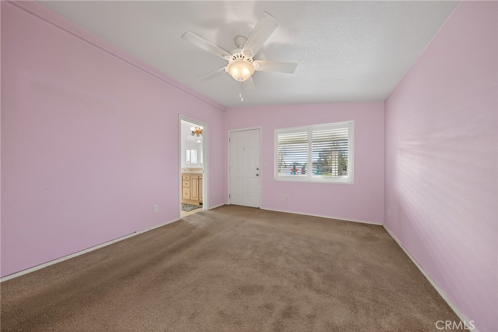 12367 4th Street, Unit 71 Yucaipa, CA 92399 - Photo 14 of 25 an empty room with windows and ceiling fan