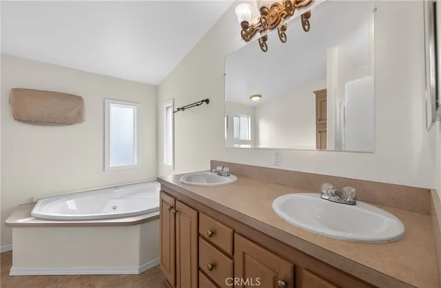 a bathroom with a granite countertop sink a toilet and mirror