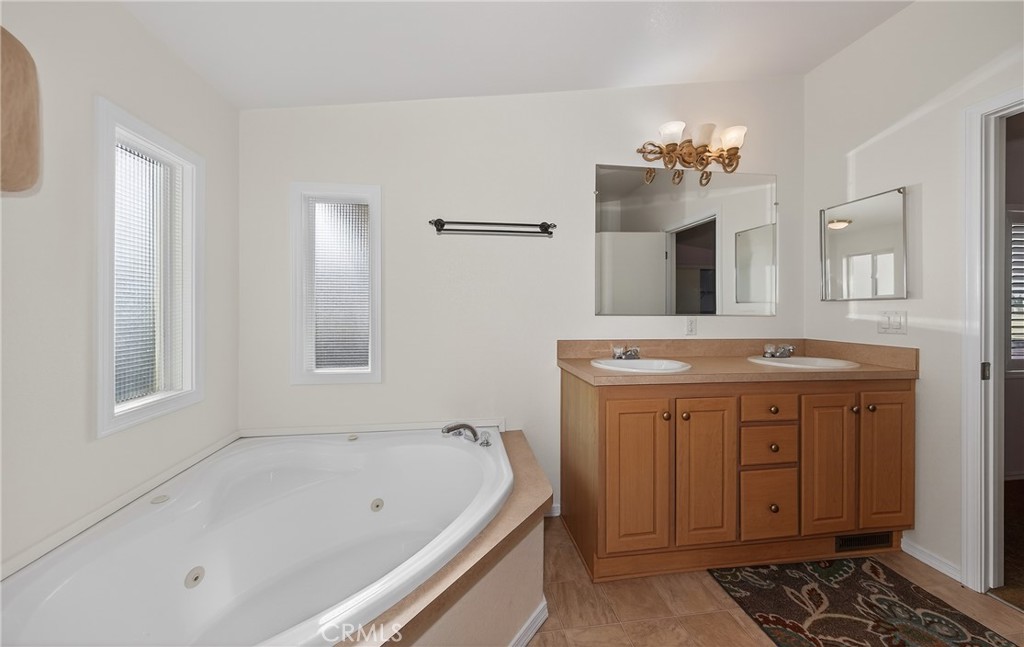 12367 4th Street, Unit 71 Yucaipa, CA 92399 - Photo 16 of 25 a bath room with a sink and a mirror