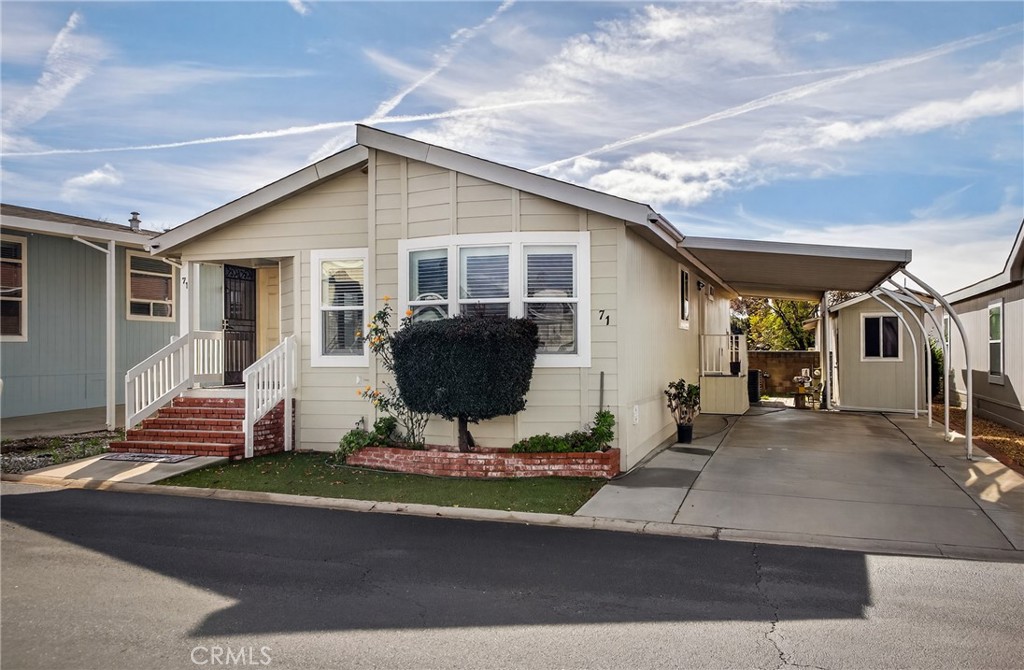 12367 4th Street, Unit 71 Yucaipa, CA 92399 - Photo 2 of 25 a front view of house with yard outdoor seating and garage