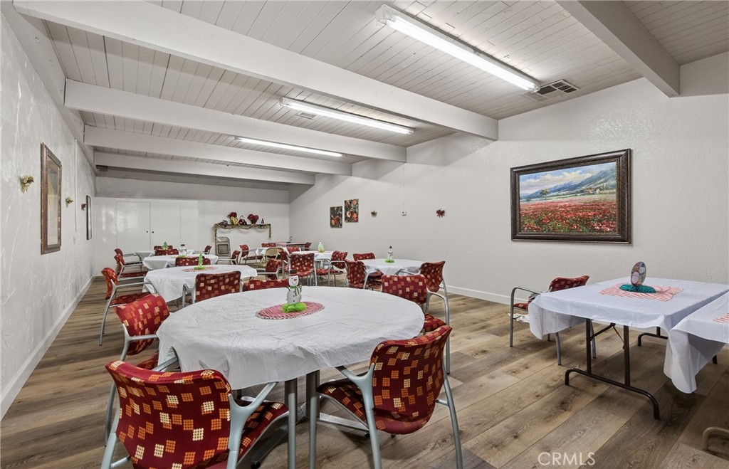 12367 4th Street, Unit 71 Yucaipa, CA 92399 - Photo 23 of 25 a view of a dining room with furniture and wooden floor