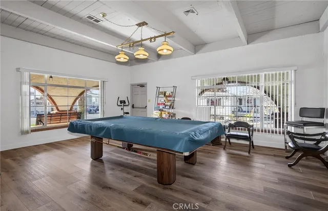 a living room with furniture a dining table and a wooden floor