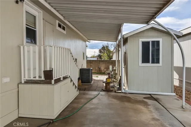 a view of a patio with table and chairs