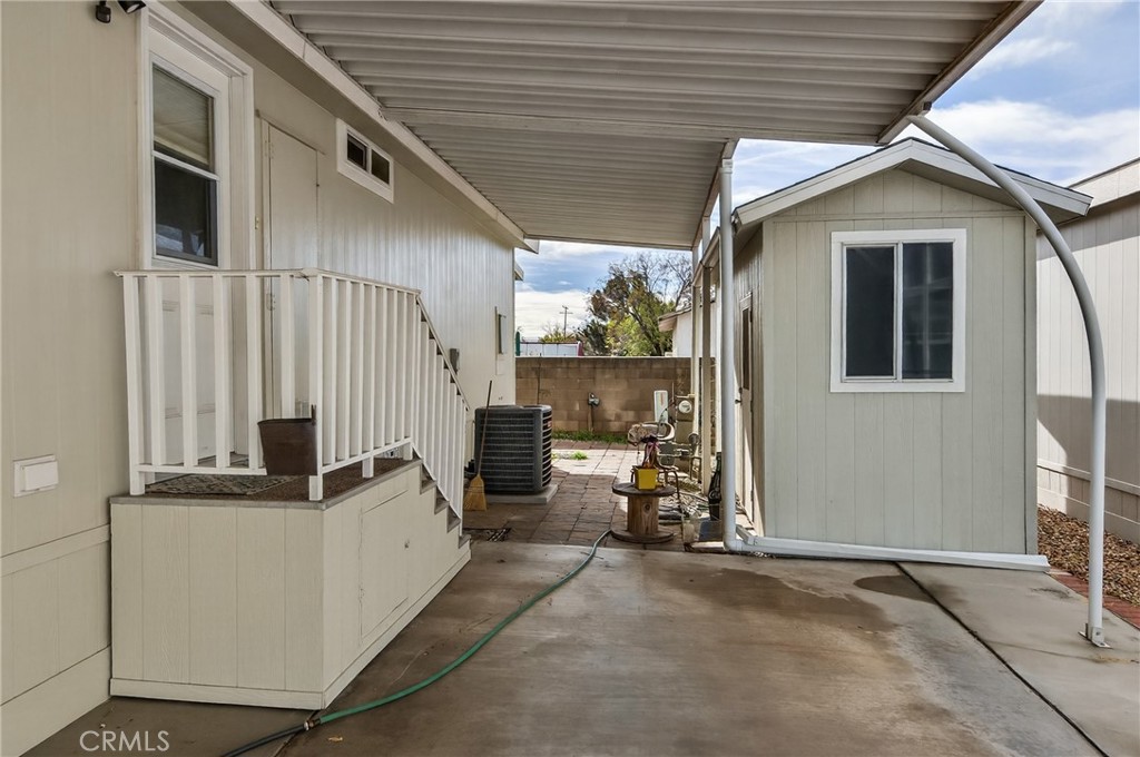 12367 4th Street, Unit 71 Yucaipa, CA 92399 - Photo 3 of 25 a view of a patio with table and chairs