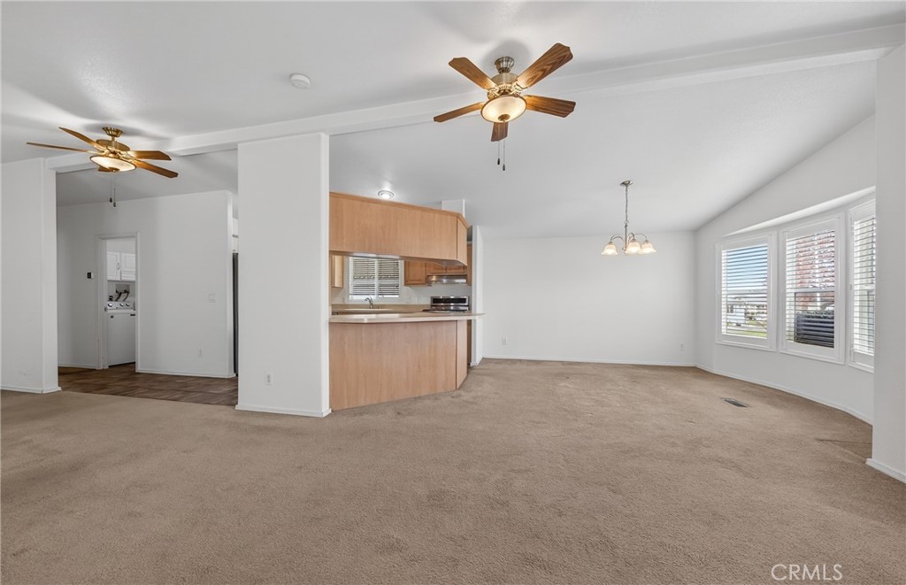 12367 4th Street, Unit 71 Yucaipa, CA 92399 - Photo 6 of 25 an empty room with chandelier fan and windows