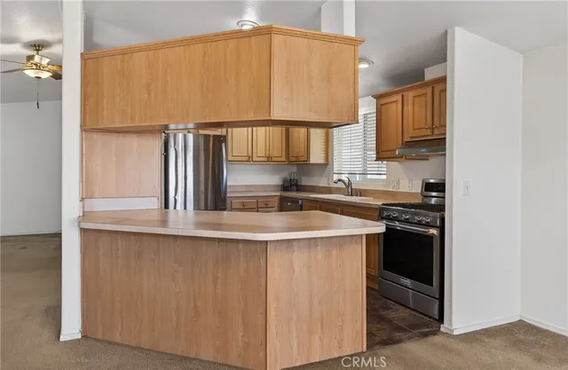 a kitchen with stainless steel appliances a sink and cabinets