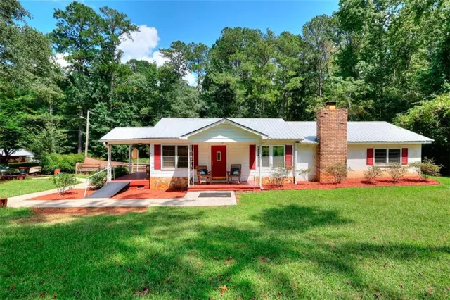 a front view of a house with swimming pool and porch