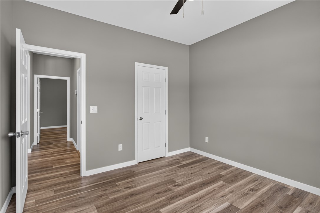 223 Maple Drive Anderson, SC 29621 - Photo 25 of 45 A well-lit room featuring durable wood-look flooring and a functional ceiling fan, ready for your personal touch.