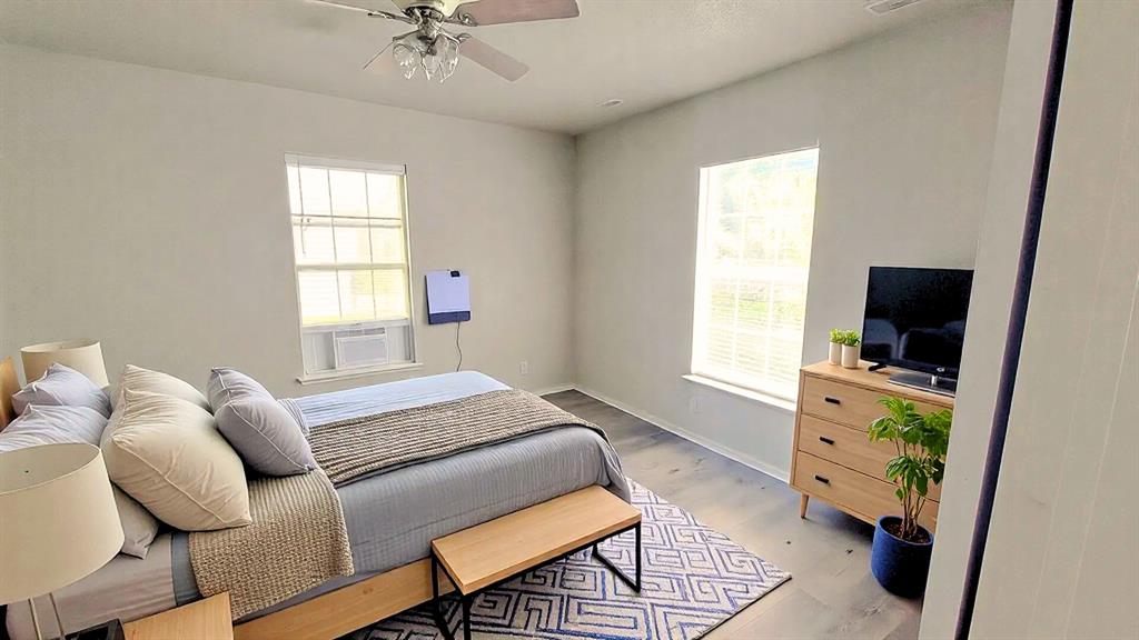 1107 Beech Street Bonham, TX 75418 - Photo 4 of 14 a bedroom with a bed and a tv