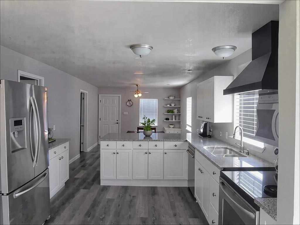 1107 Beech Street Bonham, TX 75418 - Photo 6 of 14 a kitchen with a sink stove and refrigerator