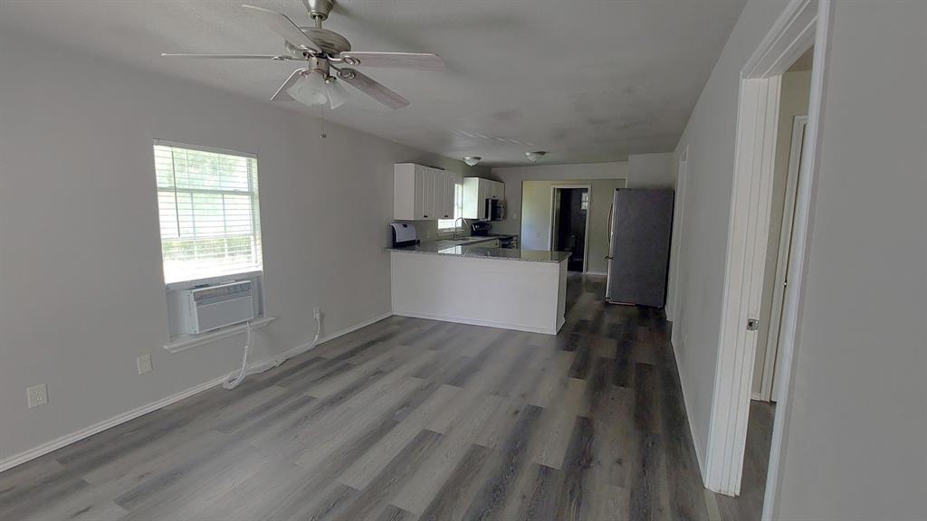 1107 Beech Street Bonham, TX 75418 - Photo 10 of 14 wooden floor in an empty room with a window