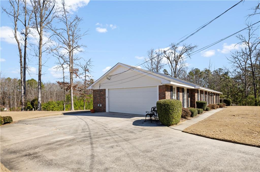 112 Thornwood Drive Southwest Rome, GA 30165 - Photo 25 of 30 a front view of a house with a yard and potted plants