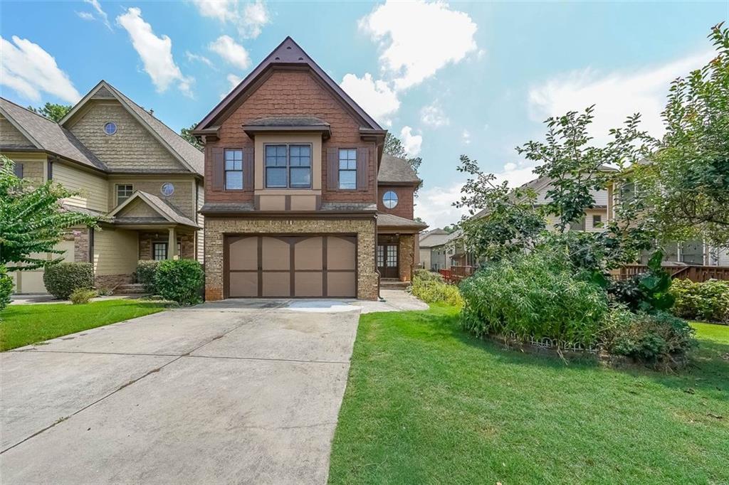 5122 Micaela Way Duluth, GA 30096 - Photo 1 of 1 a front view of a house with a garden and plants