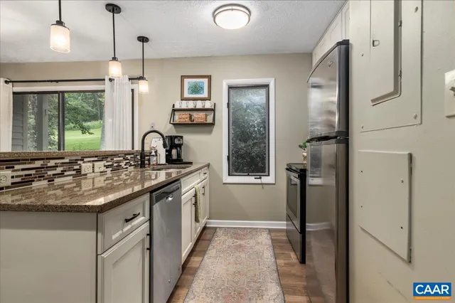 a kitchen with a sink and refrigerator