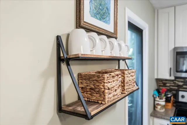 a living room with furniture a flat screen tv and a large window