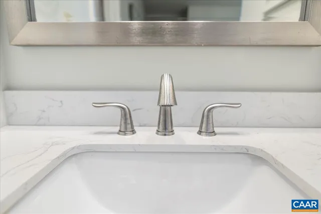 a bed room with a bed and a painting on the wall