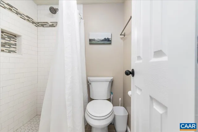 a bedroom with bed and wooden floor