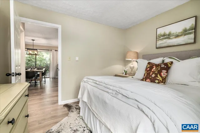 an aerial view of residential houses with outdoor space and trees
