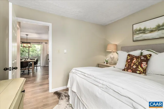 an aerial view of residential house with outdoor space and trees all around