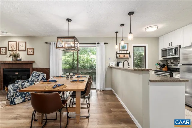 an aerial view of residential houses with outdoor space and trees