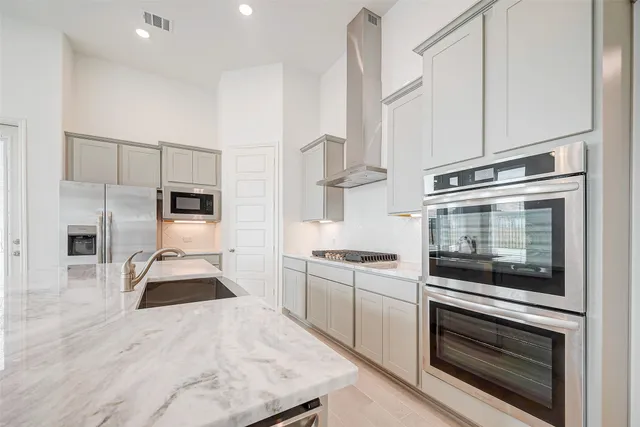 a kitchen with stainless steel appliances a refrigerator and a stove