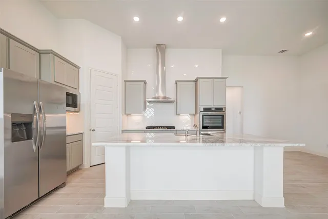 a kitchen with granite countertop cabinets and stove top oven