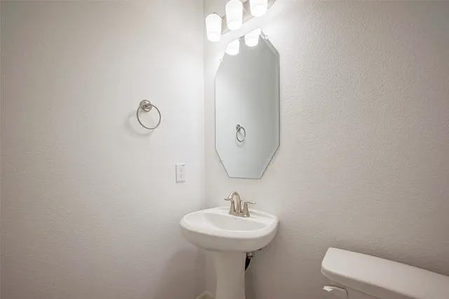 a bathroom with a sink vanity and a mirror