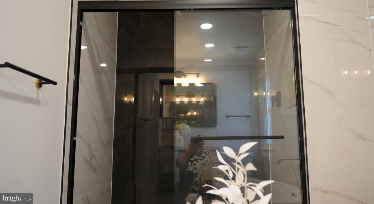5114 Montgomery Road Ellicott City, MD 21043 - Photo 20 of 34 Sleek modern shower with elegant design.