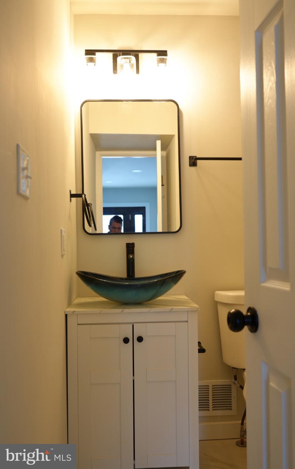 5114 Montgomery Road Ellicott City, MD 21043 - Photo 26 of 34 Sleek modern bathroom with elegant fixtures.