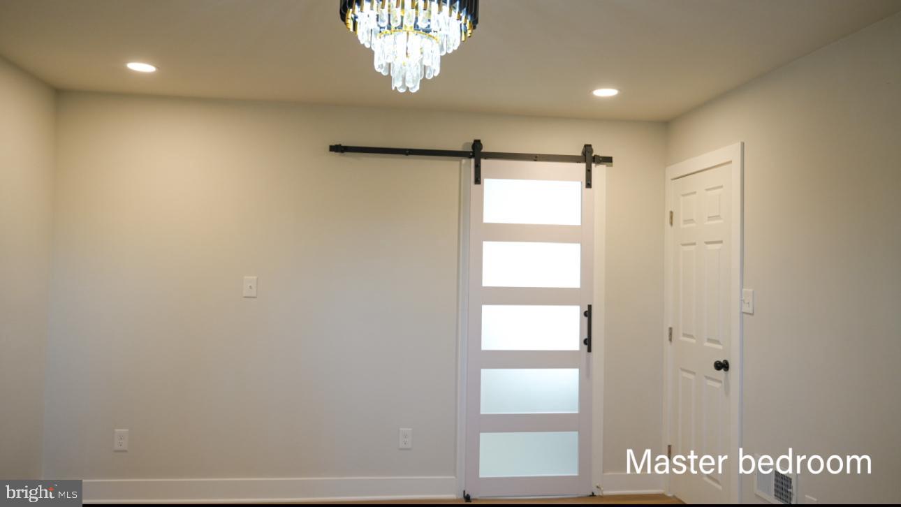 5114 Montgomery Road Ellicott City, MD 21043 - Photo 30 of 34 Elegant master bedroom with modern charm.