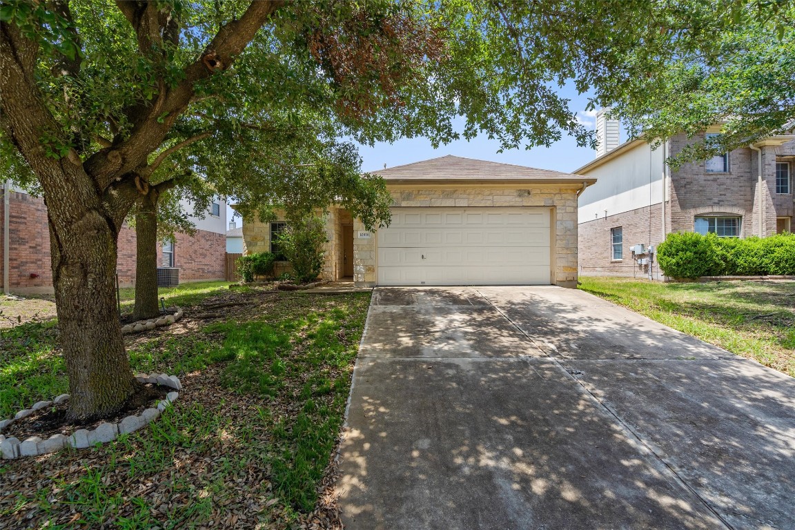 Undisclosed Address Austin, TX 78754 - Photo 1 of 1 a front view of a house with a yard and garage