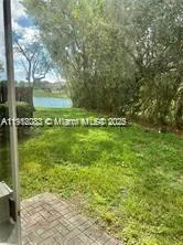 a kitchen with a refrigerator and a stove top oven